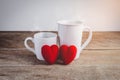 Couple Hearts and Couple coffee cups on wooden table