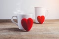 Couple Hearts and Couple coffee cups on wooden table