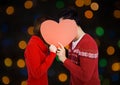 Couple hiding their face behind red heart Royalty Free Stock Photo