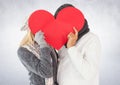 Couple hiding their face behind red heart Royalty Free Stock Photo