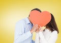 Couple hiding their face behind red heart Royalty Free Stock Photo