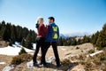 Couple of hikers with backpack standing top of mountain