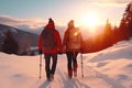 Couple of hikers with backpacks hiking in winter mountains at sunset with Generative AI. Royalty Free Stock Photo