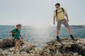 Couple of hikers on a cliffs. Young backpackers on mountain hiking