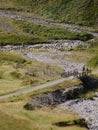 Couple of hikers crossing bridge over dry river, Glencoe, Scotland Royalty Free Stock Photo