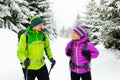 Couple hikers trekking on snow in winter woods Royalty Free Stock Photo