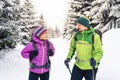 Couple hikers trekking in winter woods Royalty Free Stock Photo