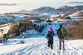 Couple of hikers walking down the hill Royalty Free Stock Photo