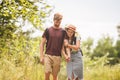 Couple Hiking Along Woodland Path. Happy loving man and woman on holiday walking together. Active lifestyle concept. Young people Royalty Free Stock Photo
