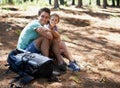 Couple, hiking break and portrait in nature for outdoor travel, adventure and wellness journey by forest. Happy man and Royalty Free Stock Photo