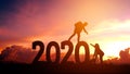 Couple hiking help each other silhouette in 2020 new year