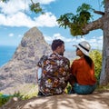 couple hiking in mountains Saint Lucia Caribbean, nature trail in jungle with view of huge Pitons Royalty Free Stock Photo