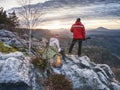 Couple hiking photographers on view point above forest