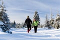 Couple hiking on snow in winter mountains Royalty Free Stock Photo