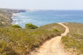 Couple hiking in Trail, mountains and vegetation in Arrifana Royalty Free Stock Photo