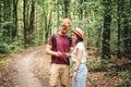 Couple hiking and using maps app on cell phone. Two people hikers looking at mobile phone trying find route. Hike in forest, Royalty Free Stock Photo