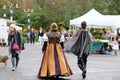 Couple in historic English costume strides into farmers market on Halloween