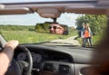 Couple hitchhiking and stopping car on countryside