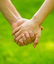 Couple hold hand in the autumn or summer park. Closeup of loving couples holding hands while walking. Female and male Royalty Free Stock Photo