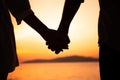 Couple hold hands in summer time on sunset at beach Royalty Free Stock Photo