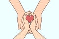 Couple hold heart in hands