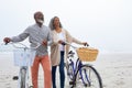 Couple holding bicycles by the beach Royalty Free Stock Photo