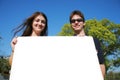 Couple holding a blank sign Royalty Free Stock Photo