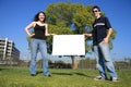 Couple holding a blank sign Royalty Free Stock Photo