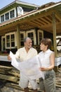 Couple Holding Building Plans