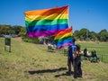 Couple holding giant gay pride flags
