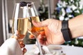 Couple holding glasses of champagne making a toast. Royalty Free Stock Photo