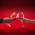 Couple holding glasses of red wine toasting Royalty Free Stock Photo