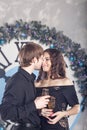 Couple holding glasses with wine. Christmas. Kiss.