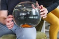 Couple holding goldfish in a fishbowl. Royalty Free Stock Photo