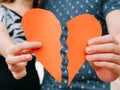 Couple holding a half heart shape breaking apart - divorce, split concept Royalty Free Stock Photo