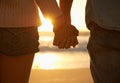 Couple, holding hands and beach or sunset love at waves for vacation journey, peace or support. Partnership, fingers and Royalty Free Stock Photo