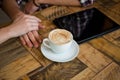 Couple holding hands with coffee cup and tablet PC on table in cafe Royalty Free Stock Photo