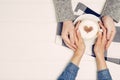 Couple Holding Hands With Coffee On White Table, Top View