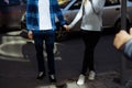 A couple holding hands and crossing the road, walking around the city. seeing, lovers Royalty Free Stock Photo