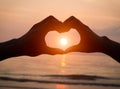 Couple holding hands heart love at sunset on beach Royalty Free Stock Photo