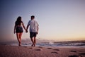 Couple, holding hands and love for beach walk together in romantic summer sunset in the outdoors. Hand hold of man and Royalty Free Stock Photo