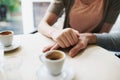 Couple, holding hands and love in coffee shop on vacation and bonding together by espresso date. Man, woman and care in Royalty Free Stock Photo