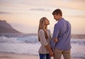 Couple, holding hands and love in looking by water, ocean waves and peace for romance in relationship. People, beach and Royalty Free Stock Photo