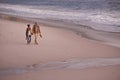 Couple, holding hands and love for walking on shore, ocean waves and peace for romance in relationship. People, beach Royalty Free Stock Photo