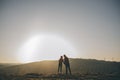 Silhouette of Romantic Couple Kissing. Couple holding hands. Couple of lover holding hand with sunrise. Royalty Free Stock Photo