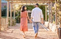 Couple, holding hands and outdoor on travel date for love, care and happiness together in nature park while talking Royalty Free Stock Photo