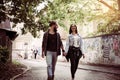 Couple holding hands outdoors. Young couple waling on the street