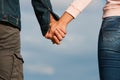 Couple holding hands over blue sky background Royalty Free Stock Photo
