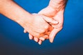 couple holding hands over blue water background Royalty Free Stock Photo