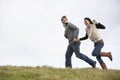 Couple Holding Hands And Running In The Park Royalty Free Stock Photo